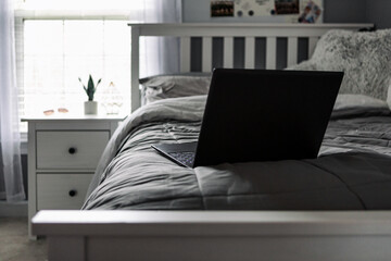 Laptoip On Bed In Teen Girl's Bedroom