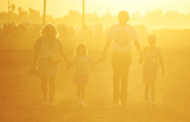 Fototapeta na wymiar happy family walking in the sunshine