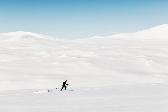 Ski Adventurer Pulling Cargo Sled Uphill