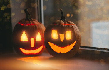 Halloween pumpkins at windows with bokeh. Happy  Halloween day.