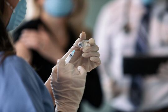 Exam: Nurse Pulling Virus Medicine Into Syringe