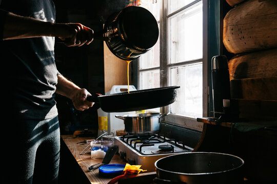 Anonymous Man Making Pancake in Cabin
