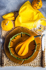 Autumnal table setting with mini pumpkin