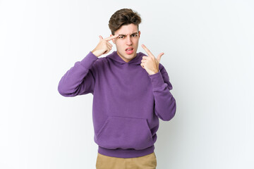 Fototapeta premium Young caucasian man isolated on white background showing a disappointment gesture with forefinger.