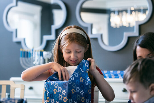 Hanukkah: Child Opening Wrapped Holiday Gift