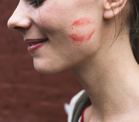 Woman with kiss print on the cheek