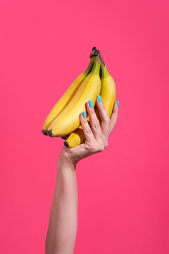 Hand holding a bunch of banana