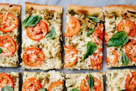 Sliced pesto, tomato and basil flatbread