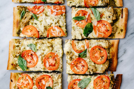 Sliced pesto, tomato and basil flatbread