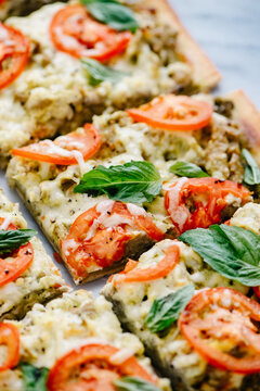 Sliced pesto, tomato and basil flatbread