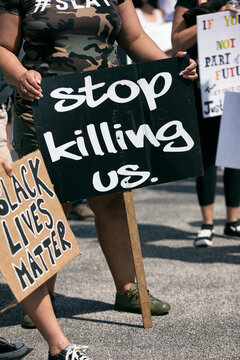 BLM: Woman Holds Sign Protesting Black Killings