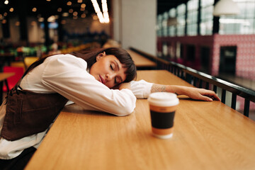 portrait of tired woman on food court