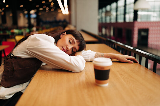 portrait of tired woman on food court