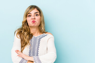 Fototapeta premium Young blonde caucasian woman shrugs shoulders and open eyes confused.