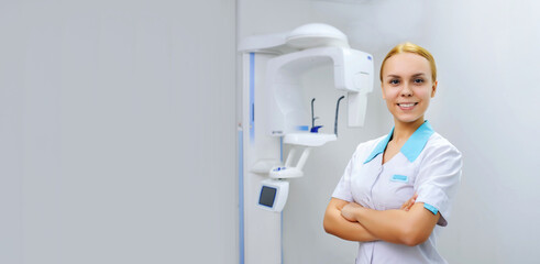 Portrait of a young woman dental x ray doctor smiling and looking at the camera in the background...