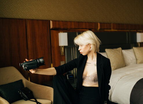 young blond woman with small camcorder