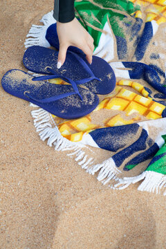 flip flops and towel on the beach