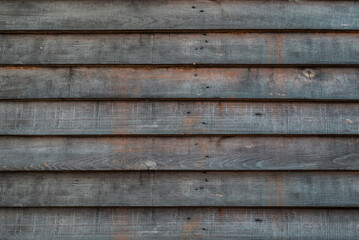 Texture dark wood home fence in the city and village