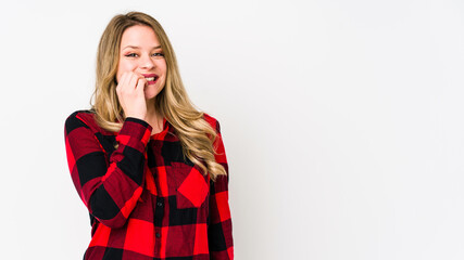 Young cauciasian woman isolated on white background biting fingernails, nervous and very anxious.