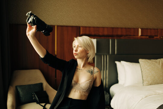 young blond woman with small camcorder