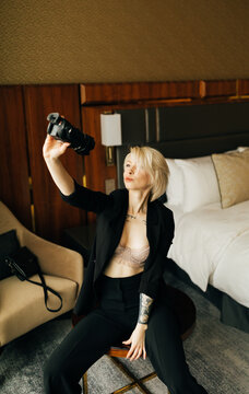 young blond woman with small camcorder