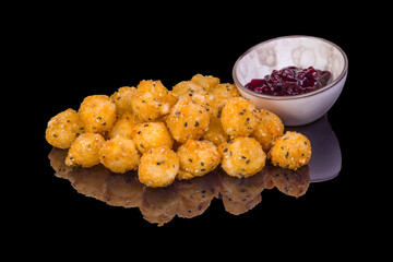 Gourmet crispy fried cheese balls and sauce, with reflection, isolated on white background