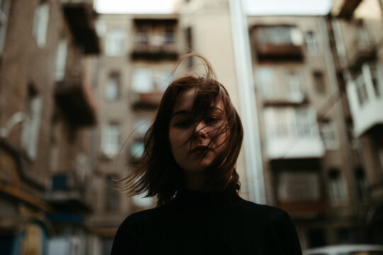 young woman on the street, windy day