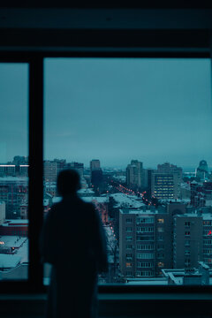 young woman near the window at night