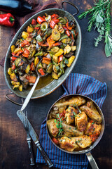 Traditional French lemon chicken with vegetable ratatoulle offered as top view in a rustic casserole
