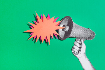 Hand holding a bullhorn