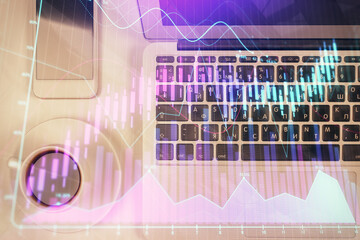 Stock market chart and top view computer on the table background. Multi exposure. Concept of financial analysis.