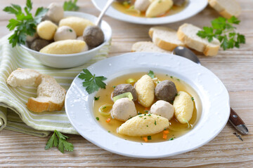 Delicious wedding soup consisting  of a strong meat broth with various small dumplings