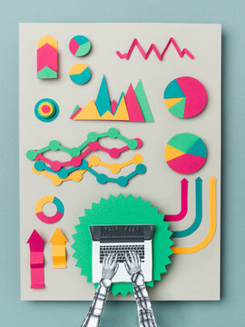 Female hands working on a laptop with a statistics papers