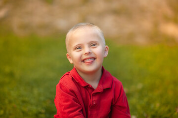 Portrait of a little cute boy with Down Syndrome, caring for sick people, genetic disease,...