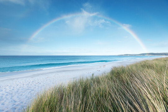 A rainbow over the sea. Bay of Fires. Tasmania. Australia.
