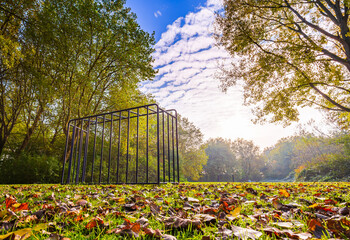 Abandoned soccer goal on a play ground, grass field on a beautiful Autumn day.