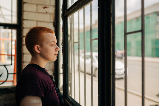 Androgyne Woman With Short Red Hair indoors
