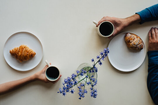 Eating croissants and coffee