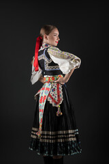 Obraz na płótnie Canvas Beautiful woman wearing traditional Eastern Europe folk costumes. Slovak folk costumes.
