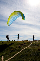 man trying to control the paraglide with friends