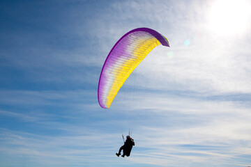 man flying free in a blue sky in a sunny day