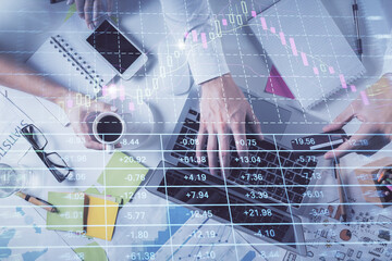 Multi exposure of man's hands typing over computer keyboard and forex graph hologram drawing. Top view. Financial markets concept.