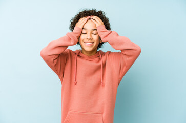African american little boy isolated laughs joyfully keeping hands on head. Happiness concept.