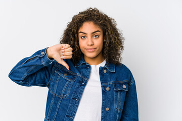 Young african american woman showing a dislike gesture, thumbs down. Disagreement concept.