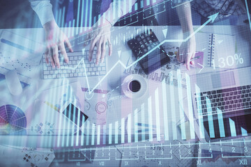 Double exposure of man and woman working together and financial chart hologram drawing. market analysis concept. Computer background. Top View.