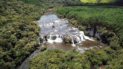 Fototapeta na wymiar Aerial view of the Ferradura waterfall, in Bom Jesus, Rio Grande do Sul, Brazil. Beautiful waterfall among the green forest in Brazil