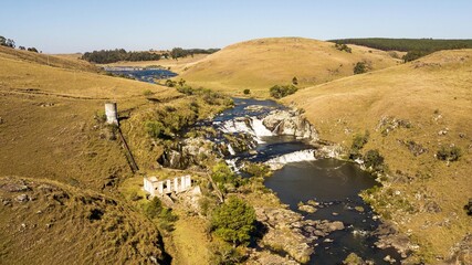 Aerial view of Usina waterfall, Rio dos Touros, Bom Jesus, Rio Grande do Sul, Brazil. Beautiful waterfall among the green fields