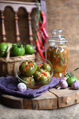 Obraz na płótnie Canvas Homemade green tomatoes preserves in glass jar, Salted green vegetable tomato.
