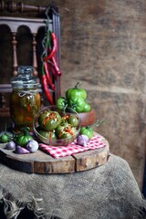 Homemade green tomatoes preserves in glass jar, Salted green vegetable tomato.