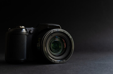 Photo camera in dark backgrond